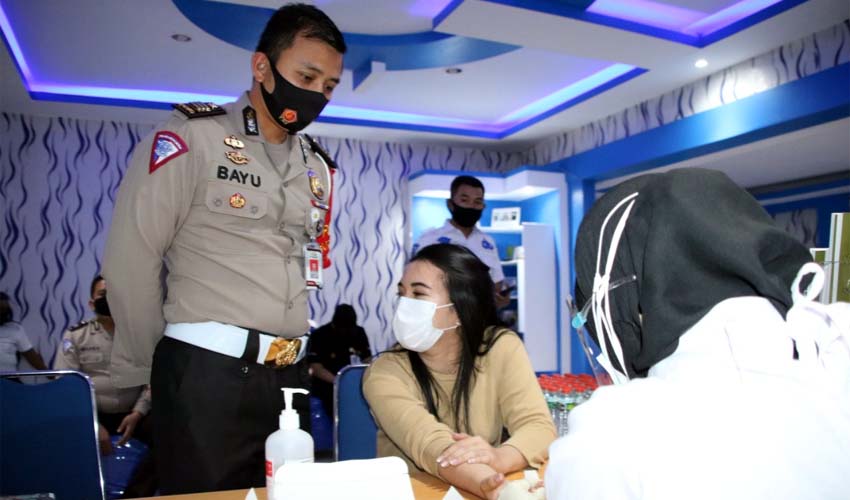 JALANI: Petugas pelayanan SIM Polresta Malang Kota saat menjalani rapid test diawasi Kanit Regident Polresta Malang Kota AKP M.Bayu Agustian S.I.K